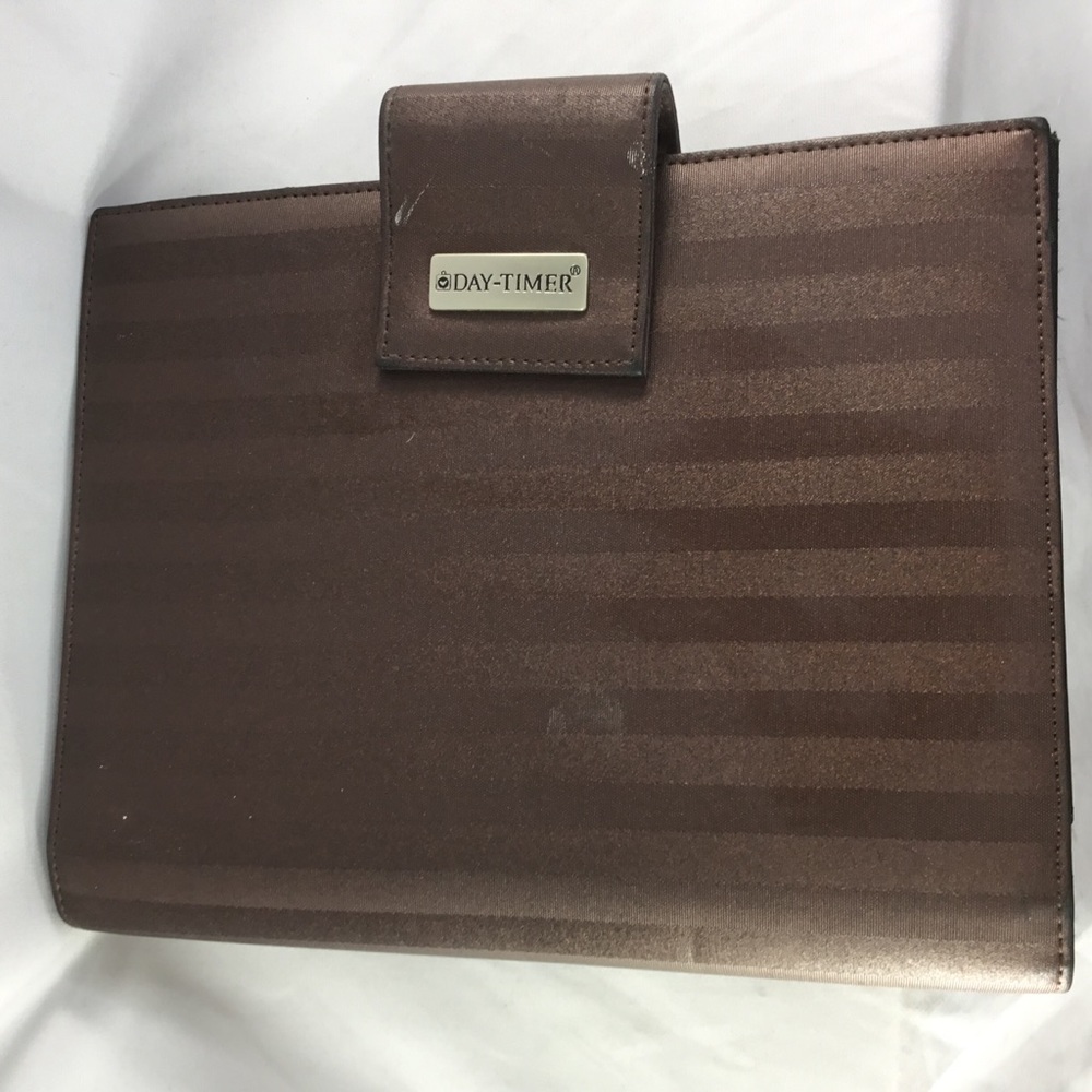 Daytimer brown striped 7 ring agenda planner.